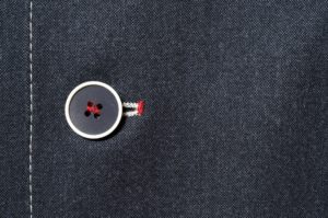 A button in a suit-like fabric